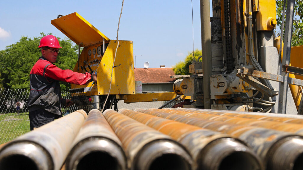 Oil and gas well drilling worker operate drilling rig machinery.