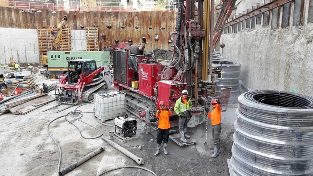 Allied Geothermal crew practicing safe processes around drilling equipment at an active construction site.
